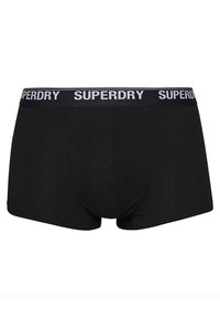 Boxers negros fabricados en tejido suave, con una amplia cinturilla elástica que lleva el logo "SUPERDRY" en blanco, diseñados para un ajuste ceñido.