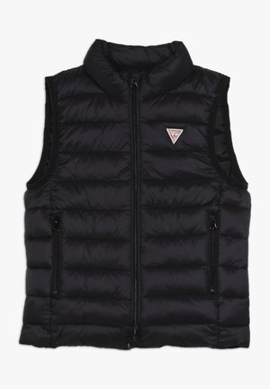 Sort quiltet udenærmet vest med høj krave, frontlynlås, to lynlåslommer og et lille trekantet Guess-logo på brystet.