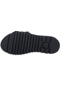 Black rubber shoe sole with horizontal grooves and diagonal treads for traction. Features a square logo embossed on the side.
