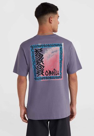 Paarse katoenen t-shirt met een grote grafische afbeelding op de achterkant, voorzien van abstracte ontwerpen in zwart, roze en blauw, omzoomd door tribale patronen.