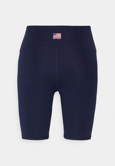 Calções de compressão azul-marinho feitos de tecido elástico, com uma cintura alta, um pequeno logótipo de bandeira e detalhes de costura limpa.