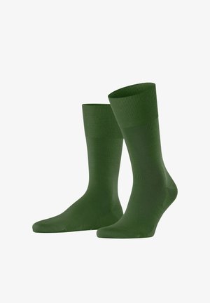 Paar schlichter dunkelgrüner Knöchelsocken mit gerippten Bündchen, dargestellt vor einem weißen Hintergrund.