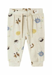 Katoenen joggingbroek in crèmekleur met dierenprints, met verschillende kleuren zoals bruin, blauw en geel. Elastiche tailleband met trekkoord.