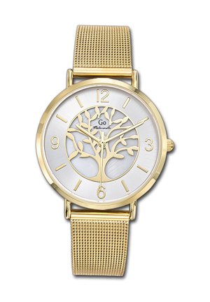 Montre dorée avec un cadran argenté présentant un motif d'arbre, des chiffres noirs aux positions 3, 6, 9 et 12, et un bracelet en maille dorée.