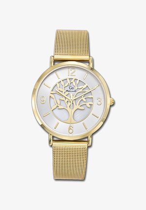 Montre dorée avec un cadran argenté présentant un motif d'arbre, des chiffres noirs aux positions 3, 6, 9 et 12, et un bracelet en maille dorée.