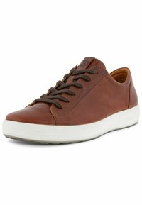 Brown leather sneaker with rounded toe, contrasting white rubber sole, and brown laces; features subtle branding on the tongue.