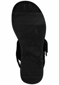 Black rubber sandal sole with textured design, featuring grooves and a logo, indicating flexibility and grip. Size marked as 37.