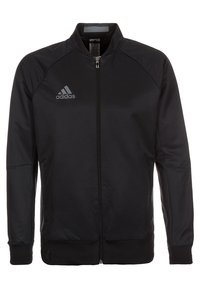 Sort zip-jakke med ståkrave, raglanærmer, glat tekstur og et gråt Adidas-logo på venstre bryst.