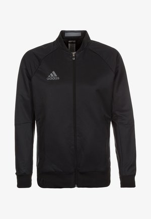 Schwarze Zip-Jacke mit Stehkragen, Raglanärmeln, glatter Textur und grauem Adidas-Logo auf der linken Brust.