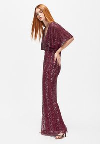 Burgunderfarbenes Pailletten-Kleid mit A-Linien-Silhouette, V-Ausschnitt, kurzen, flatternden Ärmeln und schimmernder Textur, bodenlang.