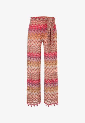 Weite Hosen mit zigzagförmigem Muster in lebhaften Farben wie Rot, Orange und Lila. Hergestellt aus einem leichten, strukturierten Stoff.