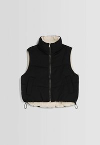 Black puffer vest with high collar, cream lining, zip closure, and two front pockets. Features elastic drawstring at the hem.