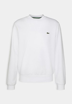 Bela crewneck majica iz mešanice bombaža, z dolgimi rokavi in malim zelenim vezenim logotipom na levi prsih. Mehek material.