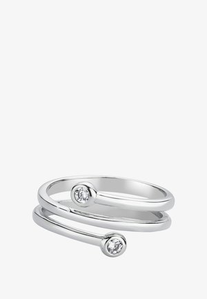 Bague argentée à double bande ornée de deux petits gemstones clairs à chaque extrémité, surface lisse et polie, design minimaliste.