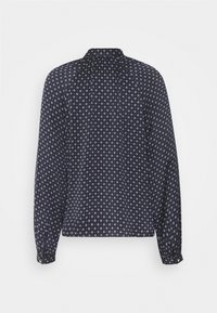 Blusa blu navy a maniche lunghe, con un motivo a diamanti bianchi. Collo rotondo e polsini con bottoni, realizzata in tessuto leggero.