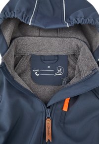 Navy waterproof jacket with gray fleece lining, full zipper closure, orange accent tab, and inner label for personalization.