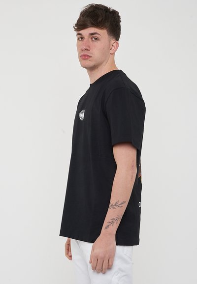 Camiseta de algodón negra con cuello redondo y mangas cortas. Presenta un pequeño logo en el pecho y una impresión gráfica en la parte posterior.