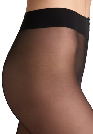 Pantys negros transparentes con una textura suave y mate y una cinturilla negra sólida. El diseño sigue las contornos de la pierna.