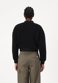 Tommy Jeans Flisinė striukė - black