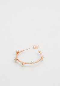 Rose gold hoop earring featuring floral accents, pearls, and sparkling details. The design includes a secure closure and textured finish.