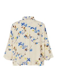 Béžová košile volného střihu s tříčtvrtečními rukávy, zdobená modrým, hnědým a žlutým květinovým motivem větviček, zobrazená zezadu.
