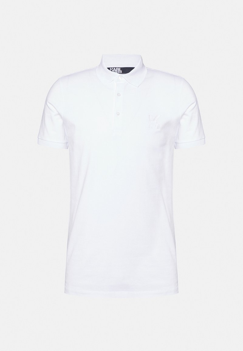 Camisa polo branca em algodão suave, com colarinho clássico, placket de três botões e um pequeno logótipo em relevo "K" no peito.