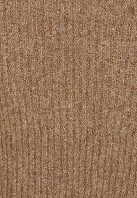 Knitted textile in a warm brown hue with vertical ribbing pattern, featuring a soft texture and slight sheen from blended fibers.