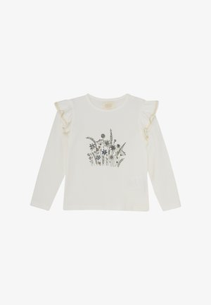 Chemisier blanc à manches longues avec illustration florale, présentant des manches ondulées avec un bord texturé. Matière en coton doux, design léger.