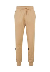 Beige joggerbukser lavet af blødt materiale, med elastisk talje med snor og sorte accentstriber på siderne.