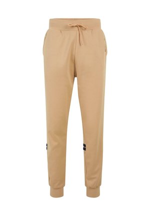 Beige joggerbukser lavet af blødt materiale, med elastisk talje med snor og sorte accentstriber på siderne.