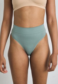 High-waisted bikini bottom in muted teal, made of smooth, stretchy fabric with minimal seam detailing, designed for a fitted silhouette.