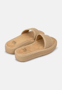 Sandali beige intrecciati con una morbida soletta simile alla pelle scamosciata e una suola spessa intrecciata. Design aperto davanti con una fascia larga sopra il piede.