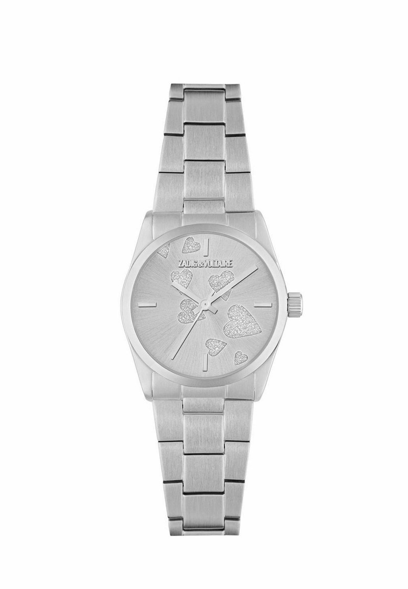 Srebrny zegarek na rękę z metalową bransoletą, sercowe akcenty z brokatem na tarczy oraz minimalne oznaczenia godzin, nazwa marki na godz. 12.