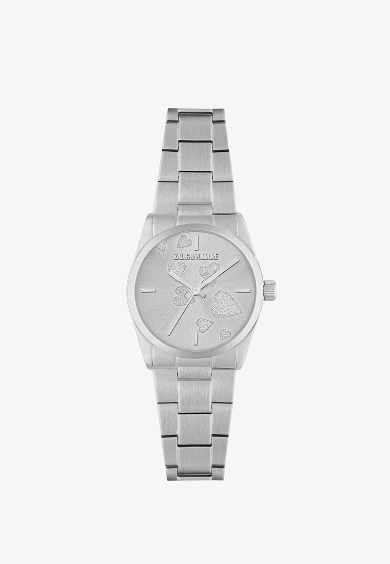 Srebrny zegarek na rękę z metalową bransoletą, sercowe akcenty z brokatem na tarczy oraz minimalne oznaczenia godzin, nazwa marki na godz. 12.