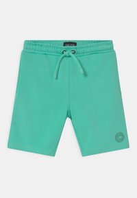 Turquoise shorts with an elastic waistband and drawstring. Features side pockets and a logo on the lower left leg. Made from soft fabric.