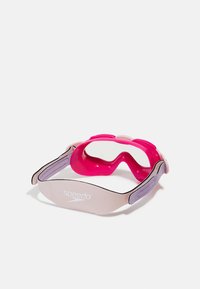 Speedo swim goggles with a soft pink frame and clear lenses, featuring a lavender strap and logo, designed for comfort and a secure fit.