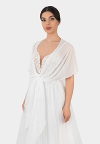 White, sheer kimono with short sleeves, a deep V-neckline, and floral lace detailing, tied with a matching ribbon at the waist.