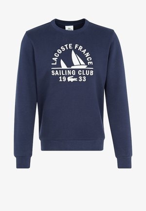 Donkerblauwe sweatshirts met de tekst "Lacoste France Sailing Club 1933" en een witte zeilbootgrafiek op de borst.