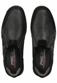 Zwarte leren schoenen met elastische zijkanten, witte stiksels, ronde neus en textuur in de binnenzolen. Het interieur bevat merketiketten.