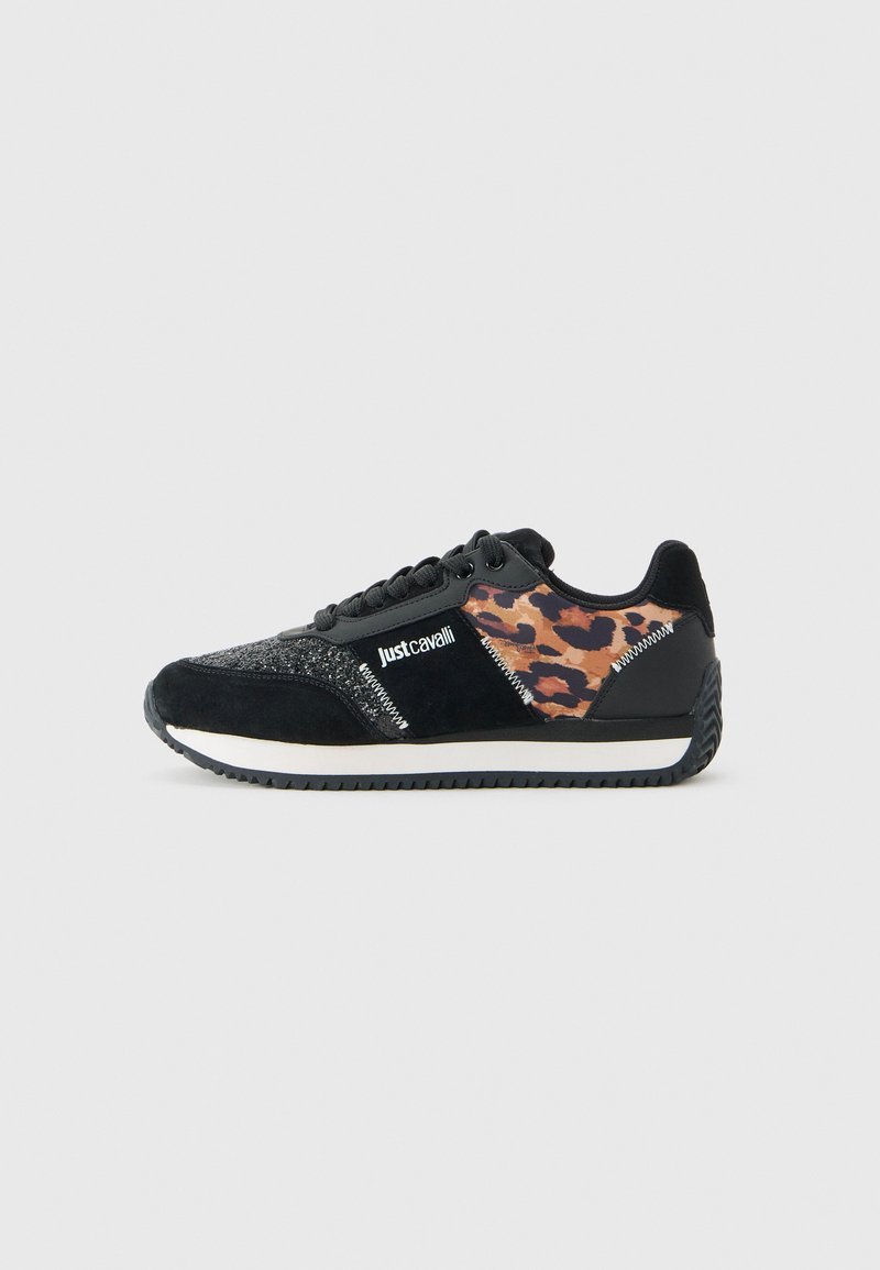 Black sneaker with leopard print panel, "Just Cavalli" logo, white sole, and textured details on a plain light background.