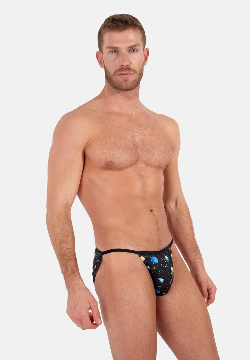 Schwarze Schwimmslips mit einem lebendigen Galaxiemuster, das Planeten und Sterne zeigt. Sie bestehen aus dehnbarem Stoff und sind mit minimalem Schnitt gestaltet.