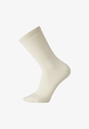 Cream-colored cotton sock, ribbed texture at the cuff, smooth body, ankle-length, no visible patterns or hardware.