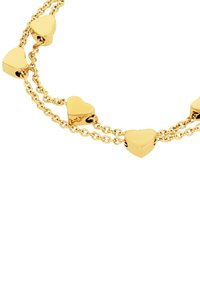 Collana in tono oro con catene collegate, pendenti a forma di cuore alternati e finitura lucida.