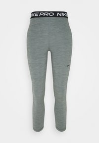Szare legginsy sportowe z dopasowanym krojem, z czarnym pasem "NIKE PRO" oraz małym czarnym logo Nike na udzie.