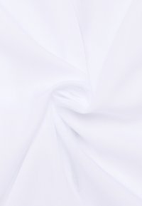 Tessuto bianco che mostra una trama liscia con una leggera lucentezza, raccolto a spirale, caratterizzato da una colorazione uniforme e un aspetto leggero.