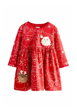 Red cotton dress featuring long sleeves, a flared skirt, and festive patterns of Santa, reindeer, and Christmas motifs. Plush Santa applique detail.