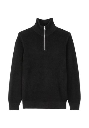 Pull noir en tricot fabriqué dans un tissu doux, avec un col montant et un court zip au niveau du cou. Poignets et ourlet côtelés.
