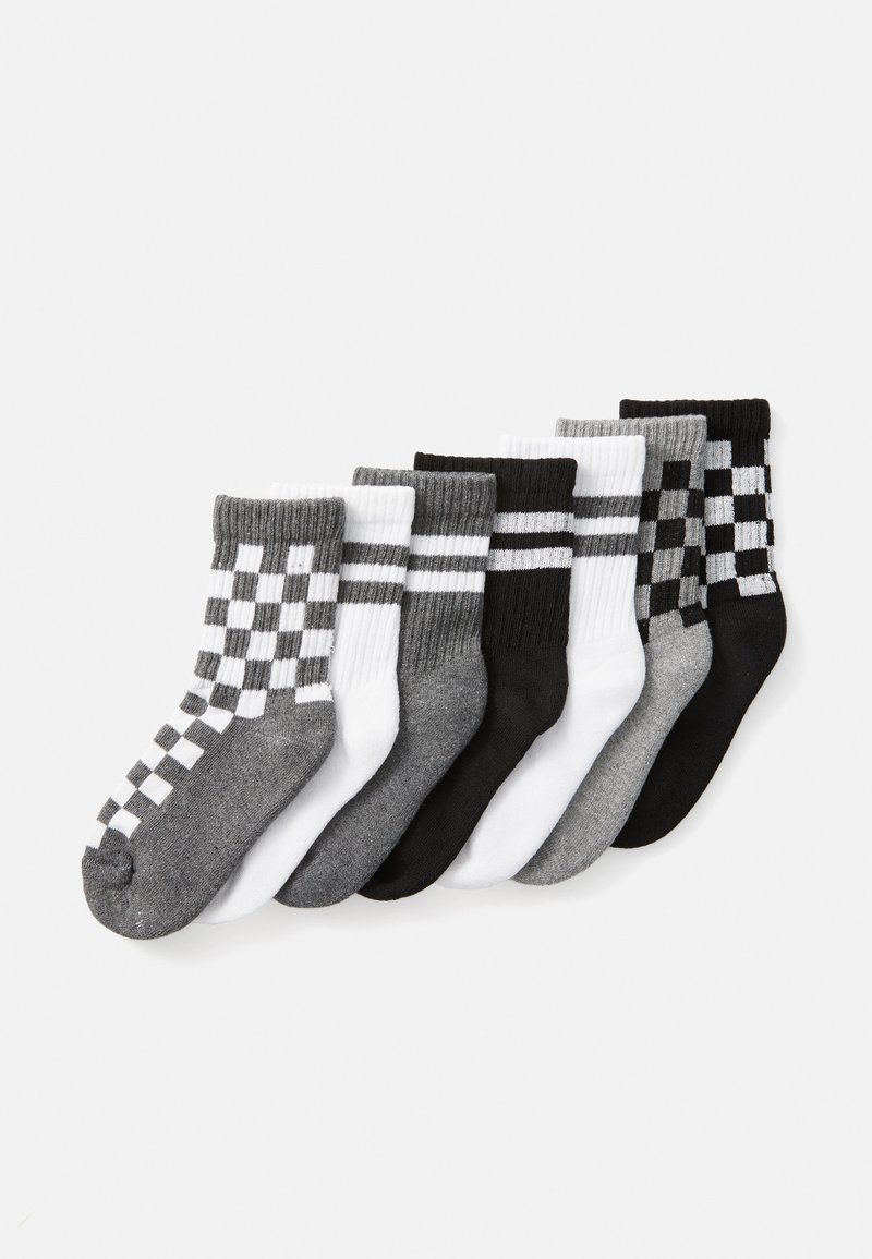 Seven pairs of crew socks: black, white, and gray. Features include stripes and checkerboard patterns, ribbed cuffs, and soft fabric texture.