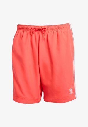 Korallikad spordilühikesed püksid elastse vöö koha ja nööri detailiga ning valgetes külgtriipudes. Pehme, kerge kangas Adidas'i logo akendiga.