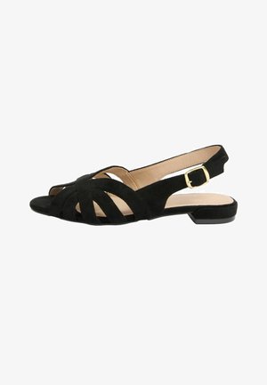 Sort ruskind slingback flad sandal med åben tå, krydsede stropper, beige indre foring og guldfarvet justerbar spænde på siden.
